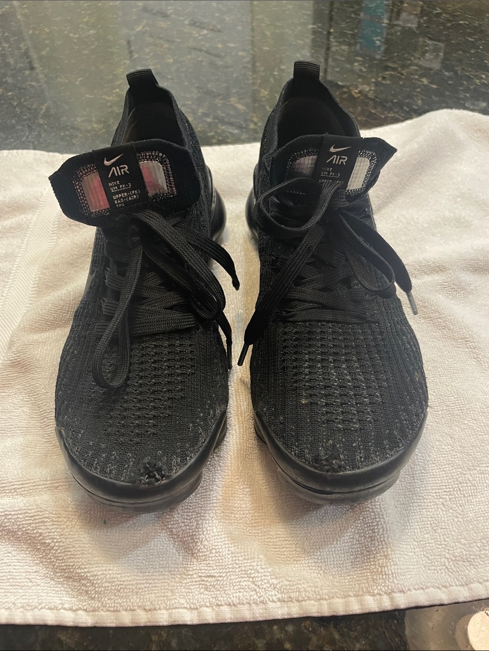Nike Black Flyknit Women’s Air Running Shoes. There is a small hole in the toe.